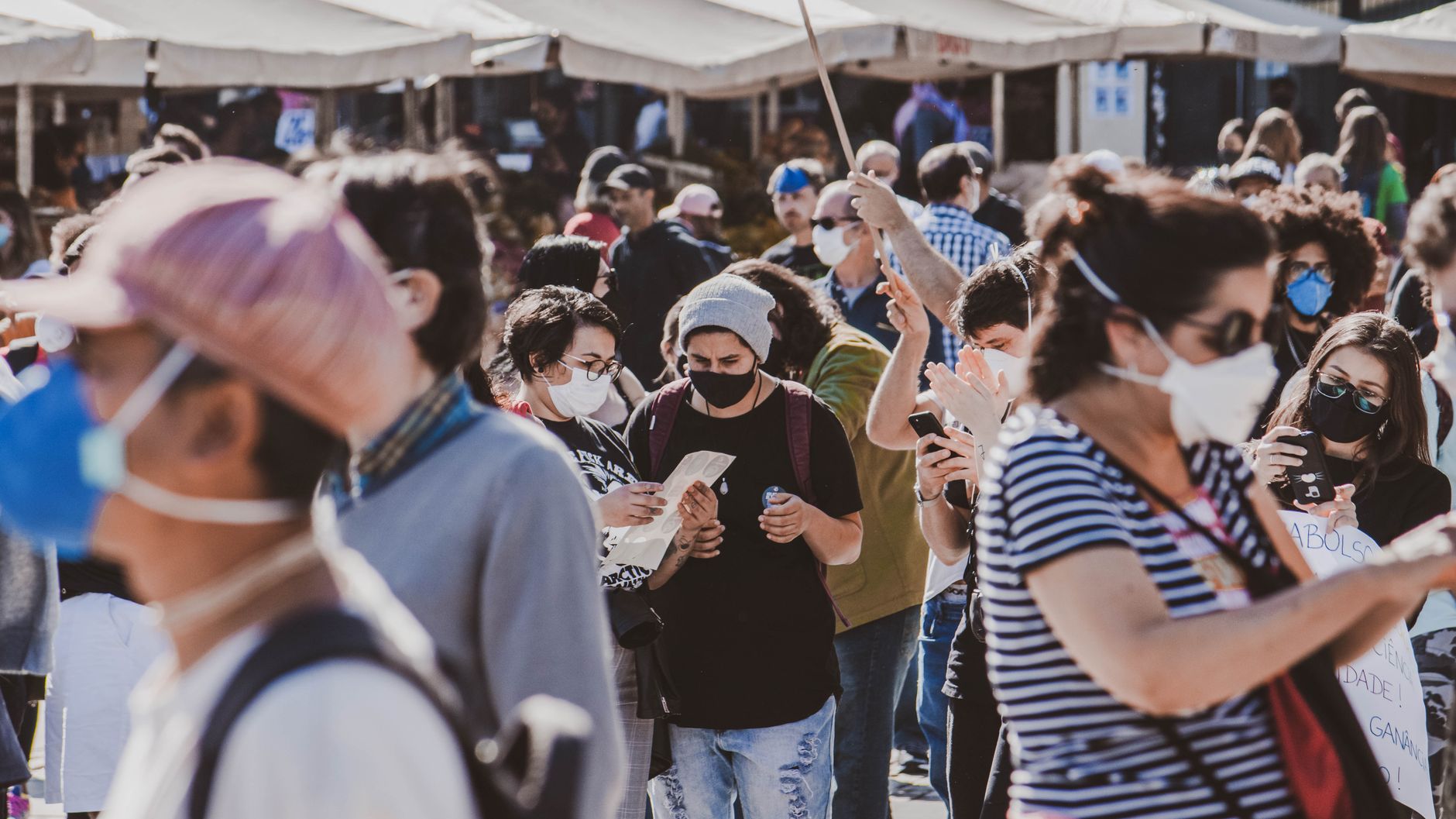 A diverse group of people wearing masks in an outdoor urban setting, highlighting community and safety. — Coronavirus disease