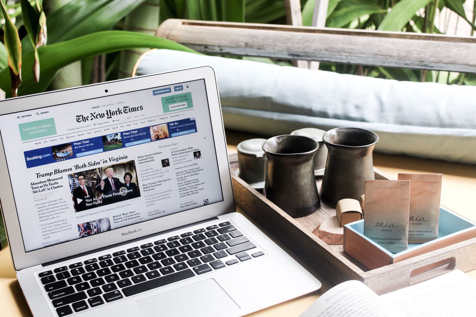 High angle of modern laptop with news on screen placed on table next to tin cups — Sensible Medical insurance Preparations