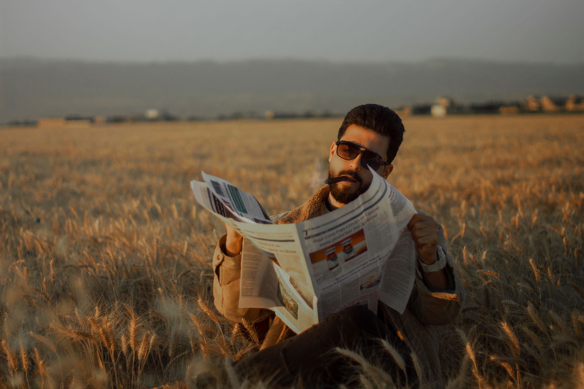 Middle-aged man sitting in a serene wheat field, reading a newspaper during the day. — Sind die Turniere im Rodeo Slot Casino